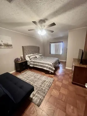 a bedroom with a bed and a ceiling fan at Spacious Lake Retreat for Families in Saint Cloud