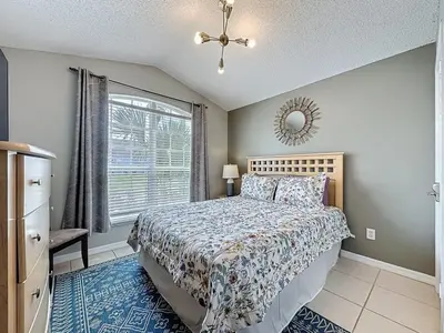 a bedroom with a bed and a window at Casa del Sol at Indian Creek Four Corners villa in Kissimmee