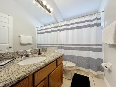 a bathroom with a sink and a toilet and a shower at Casa del Sol at Indian Creek Four Corners villa in Kissimmee