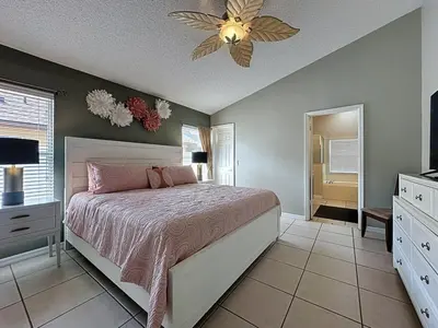 a bedroom with a bed and a ceiling fan at Casa del Sol at Indian Creek Four Corners villa in Kissimmee