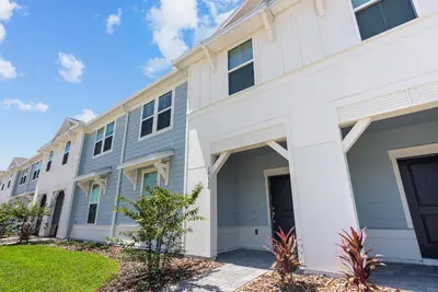 a large white building with a driveway at Brand NEW 05 Bedrooms At Windsor Cay in Orlando