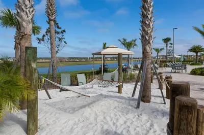 a hammock on the beach with palm trees at Brand NEW 05 Bedrooms4 Baths At Storey Lake in Kissimmee
