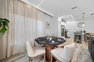 a living room with a table and chairs at Brand NEW 05 Bedrooms4 Baths At Storey Lake in Kissimmee