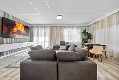 a living room with a couch and a fireplace at Brand NEW 05 Bedrooms4 Baths At Storey Lake in Kissimmee