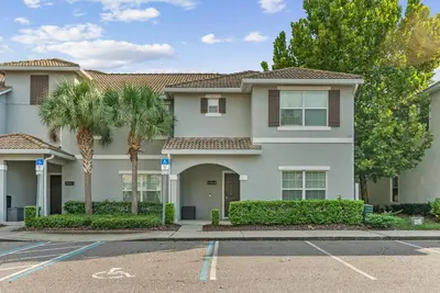 a house with palm trees in a parking lot at Brand NEW 05 Bedrooms4 Baths At Storey Lake in Kissimmee