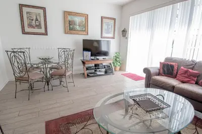 a living room with a table and chairs and a couch at NEW - Paradise townhome at Windsor Hills in Orlando