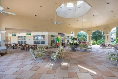a large room with chairs and tables and a ceiling at NEW - Paradise townhome at Windsor Hills in Orlando
