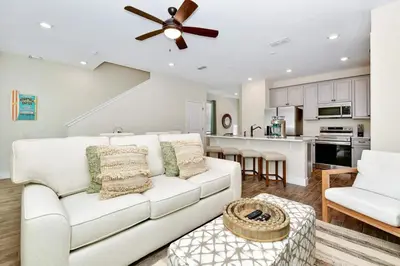 a living room with a white couch and a ceiling fan at Paradise Breeze Cottage by Shine Villas - Margaritaville Resort Orlando condo in Orlando