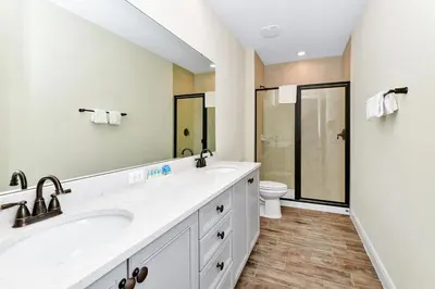 a bathroom with two sinks and a toilet at Paradise Breeze Cottage by Shine Villas - Margaritaville Resort Orlando condo in Orlando