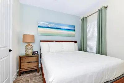 a bedroom with a bed and a window at Paradise Breeze Cottage by Shine Villas - Margaritaville Resort Orlando condo in Orlando