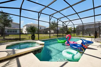 a pool with two inflatable toys in a house at Enchanted Escape-Perfect Pool to Relax & Recharge in Kissimmee