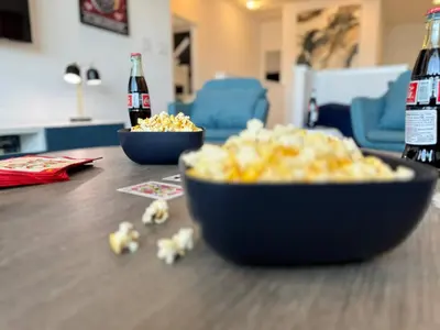 a table with two bowls of popcorn and two bottles of soda at Enchanted Escape-Perfect Pool to Relax & Recharge in Kissimmee