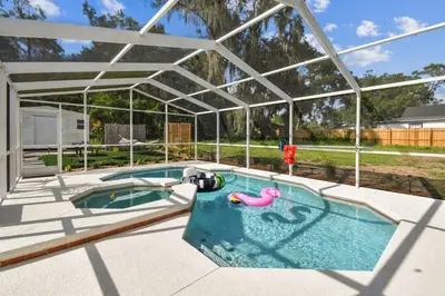 a swimming pool with a pool noodle in a pavilion at Relaxing Modern Home Sleeps 6 Pool BBQ Firepit in Sorrento