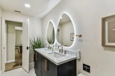 a bathroom with a sink and a mirror at Relaxing Modern Home Sleeps 6 Pool BBQ Firepit in Sorrento