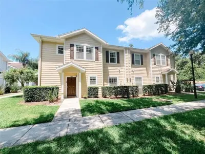 a large house with a driveway at 4 Bedrooms 3 Bathrooms Lucaya 10-108 in Kissimmee
