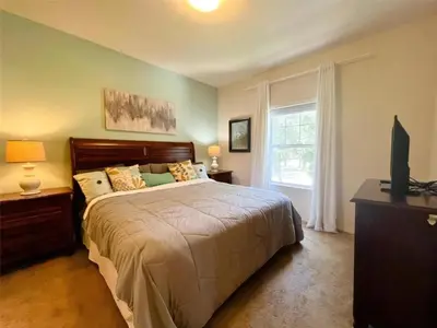a bedroom with a large bed and a window at 4 Bedrooms 3 Bathrooms Lucaya 10-108 in Kissimmee