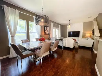 a dining room and living room with a table and chairs at 4 Bedrooms 3 Bathrooms Lucaya 10-108 in Kissimmee