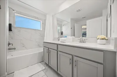 a white bathroom with a tub and a sink at 4 Bedrooms 3 Bathrooms Storey Lake 2952 Ps in Kissimmee