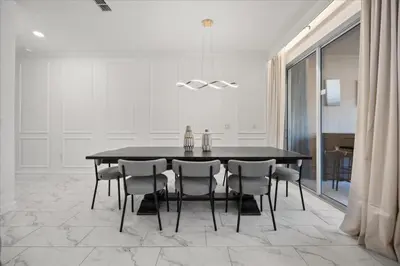 a dining room with a black table and chairs at 4 Bedrooms 3 Bathrooms Storey Lake 2952 Ps in Kissimmee