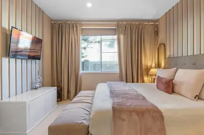 a bedroom with a large bed and a window at 4 Bedrooms 45 Bathrooms Magic Village7603Rd in Orlando