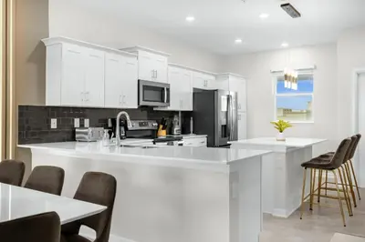 a kitchen with white cabinets and a white counter top at 2 Bedrooms 2 Bathrooms Storey Lake 3151-404 in Kissimmee
