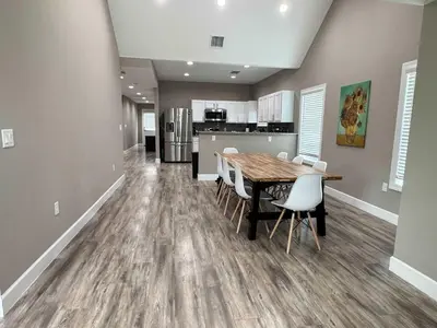 a kitchen and dining room with a wooden table and chairs at Peace in the Garden - Home in Winter Garden in Orlando