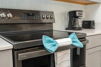 a kitchen with a stove with blue towels on it at Private Pool - Themed Rooms - Near Disney 4239 in Kissimmee