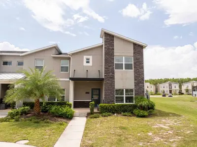 a house with a palm tree in front of it at Private Pool - Themed Rooms - Near Disney 4239 in Kissimmee