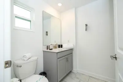 a white bathroom with a toilet and a mirror at Private Pool - Themed Rooms - Near Disney 4239 in Kissimmee
