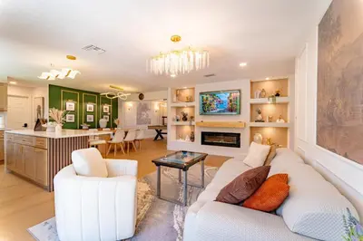 a living room with a white couch and a kitchen at Spacious Modern Japandi Retreat - Winter Park in Orlando
