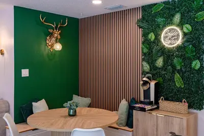 a room with a table and a green wall at Spacious Modern Japandi Retreat - Winter Park in Orlando