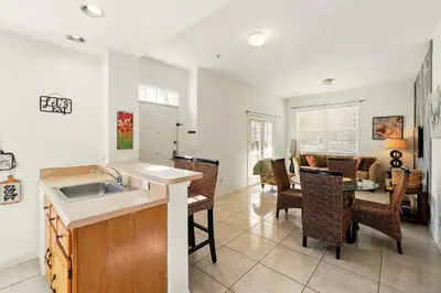 a kitchen with a sink and a table with chairs at Your Orlando Escape - Gated Resort with Amenities in Kissimmee