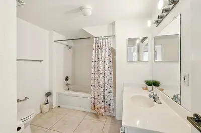 a white bathroom with a tub and a sink at Your Orlando Escape - Gated Resort with Amenities in Kissimmee