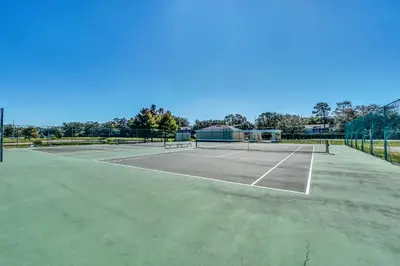 a tennis court with two tennis rackets on it at Your Orlando Escape - Gated Resort with Amenities in Kissimmee