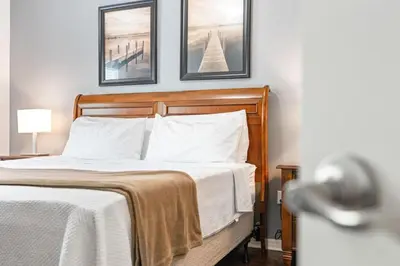 a bed in a bedroom with two pictures on the wall at Amazing 3 Bdr House near Disney - LV22106 in Kissimmee