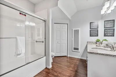 a white bathroom with a shower and a toilet at Amazing 3 Bdr House near Disney - LV22106 in Kissimmee