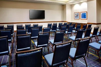 a conference room with chairs and a flat screen tv at Courtyard by Marriott Orlando Lake Nona in Orlando