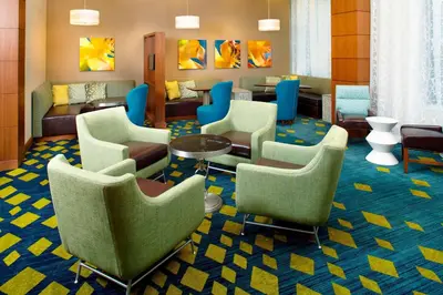 a waiting room with chairs and a table at Residence Inn by Marriott Orlando Lake Nona in Orlando