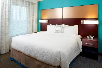 a bed in a hotel room with a large white bed at Residence Inn by Marriott Orlando Lake Nona in Orlando