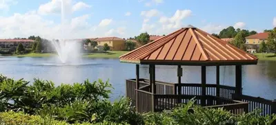 a gazebo in the middle of a lake with a fountain at NEW - Townhome on amazing resort - private hot tub in Kissimmee