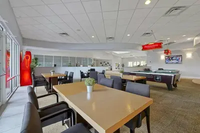 a restaurant with tables and chairs and a pool table at NEW - Townhome on amazing resort - private hot tub in Kissimmee