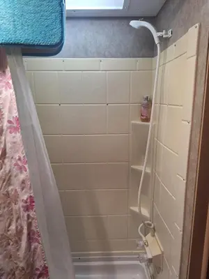 a bathroom with a shower and a sink at Tiny Trailer happy hole in the wall in Orlando