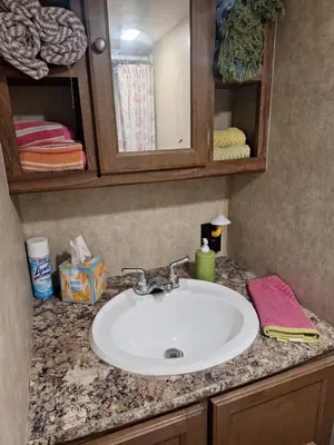 a bathroom counter with a sink and a mirror at Tiny Trailer happy hole in the wall in Orlando