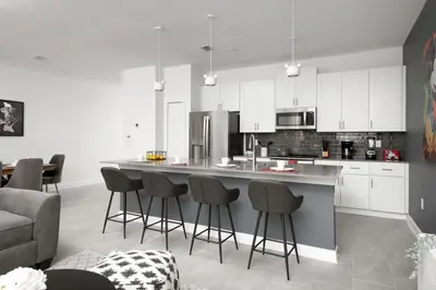 a kitchen with a large island with bar stools at Resort completo a minutos da Disney e outlets in Kissimmee
