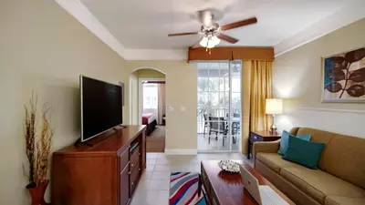 a living room with a couch and a flat screen tv at Calypso Cay Vacation Villas in Kissimmee