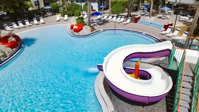 a swimming pool with a slide in a resort at Calypso Cay Vacation Villas in Kissimmee