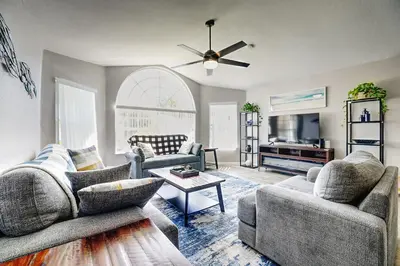 a living room with two couches and a ceiling fan at 3BD Townhome with Pool 12mi to Disney and Universal in Kissimmee