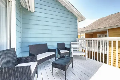 a patio with chairs and tables on a house at 3BD Townhome with Pool 12mi to Disney and Universal in Kissimmee