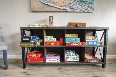 a book shelf with food and snacks on it at 3BD Townhome with Pool 12mi to Disney and Universal in Kissimmee