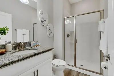 a bathroom with a shower and a toilet and a sink at Go08 - STOREY LAKE in Kissimmee